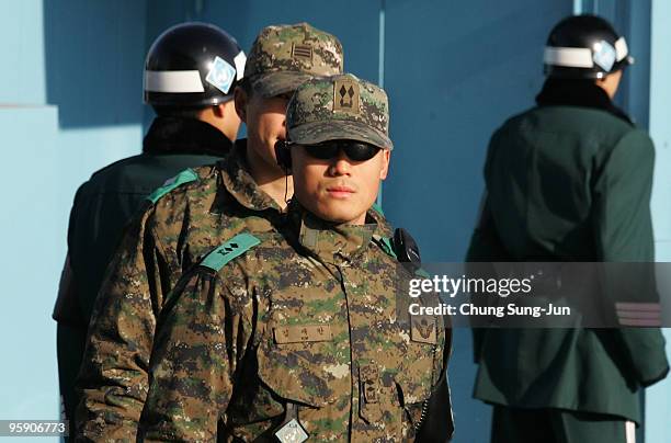 South Korean soldiers stands guard near the South side of the border in the village of Panmunjom between South and North Korea in the demilitarized...