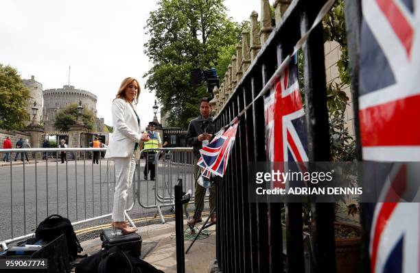Journalist Anna Stewart prepares to make a live braodcast near Windsor Castle in Windsor, west of London on May 16 as preparations continue ahead of...