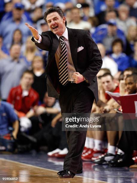 Rick Pitino the Head Coach of the Louisville Cardinals gives instructions to his team during the game against the Kentucky Wildcats at Rupp Arena on...