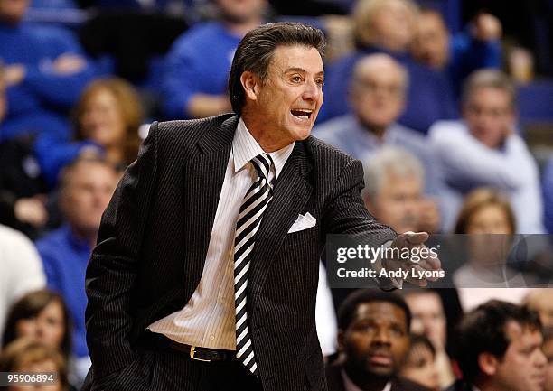 Rick Pitino the Head Coach of the Louisville Cardinals gives instructions to his team during the game against the Kentucky Wildcats at Rupp Arena on...