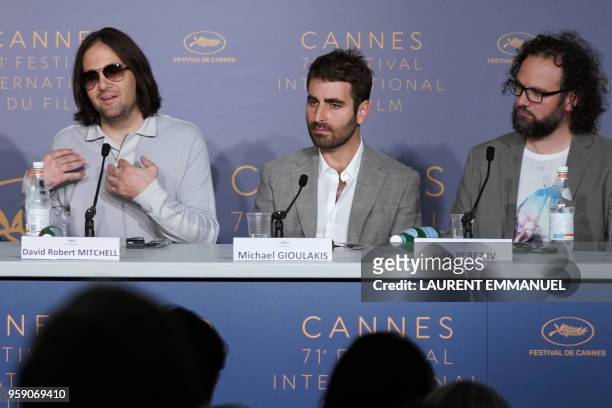 Director David Robert Mitchell speaks as US director of photography Mike Gioulakis and US editor Julio Perez IV listen during a press conference on...