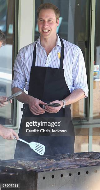 Prince William cooks on a BBQ as he visits the bushfire affected township of Flowerdale on the third day of his visit to Australia on January 21,...