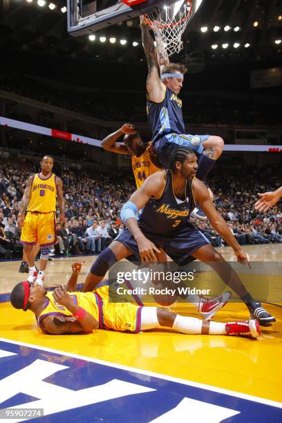 Chris Andersen and Nene Hilario of the Denver Nuggets vie for the ball against Cartier Martin and Anthony Tolliver of the Golden State Warriors on...