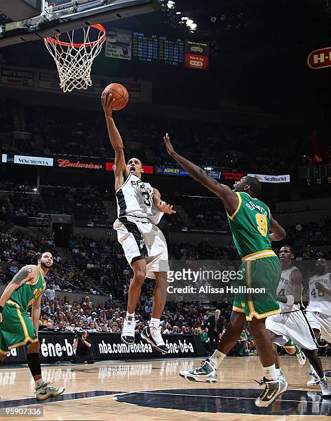 George Hill of the San Antonio Spurs shoots against Ronnie Brewer of the Utah Jazz on January 20, 2010 at the AT&T Center in San Antonio, Texas. NOTE...