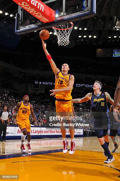 Andris Biedrins of the Golden State Warriors scores against Chris Andersen of the Denver Nuggets on January 20, 2010 at Oracle Arena in Oakland,...