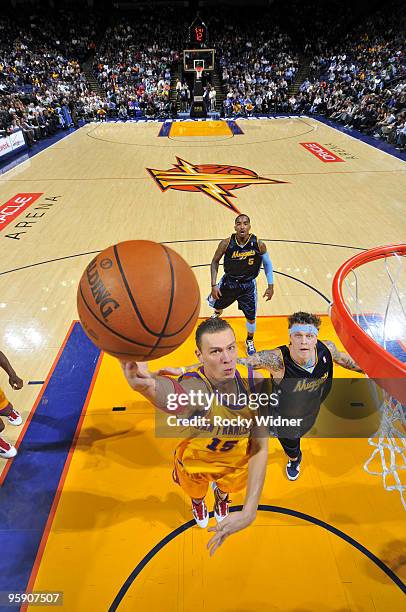 Andris Biedrins of the Golden State Warriors scores in the paint against Chris Andersen of the Denver Nuggets on January 20, 2010 at Oracle Arena in...