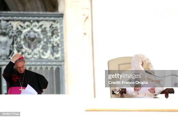 Pope Francis, flanked by Prefect of the papal household Georg Gaenswein , holds his homily as a gust of wind catches his mantle during his weekly...