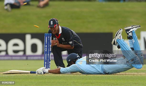 Saurabh Netravalkar of India dives to make his ground as Azeem Rafiq of England attempts a runout during the ICC U19 Cricket World Cup match between...