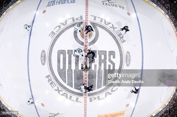 Shawn Horcoff of the Edmonton Oilers faces off against Henrik Sedin of the Vancouver Canucks at the start of the game at Rexall Place on January 20,...