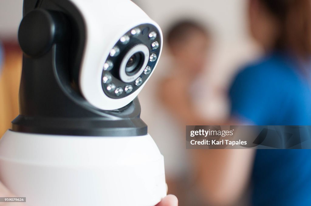 A concept of security camera watching a baby