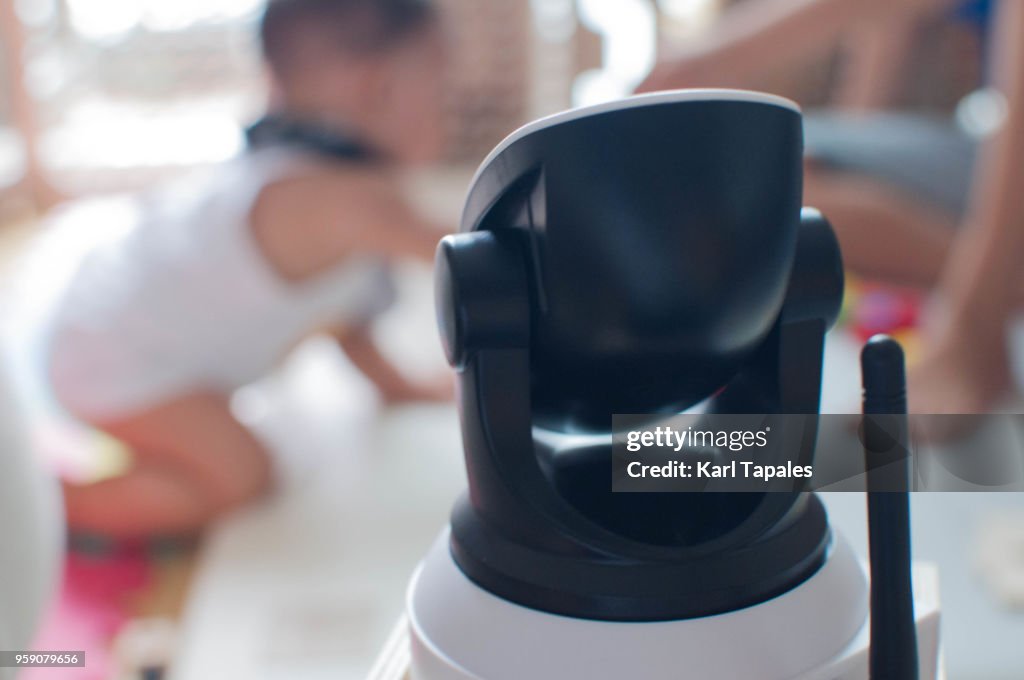 A concept of security camera watching a baby