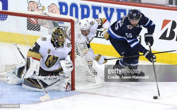 Mark Scheifele of the Winnipeg Jets rounds the net as Nate Schmidt and Marc-Andre Fleury of the Vegas Golden Knights defend in Game Two of the...