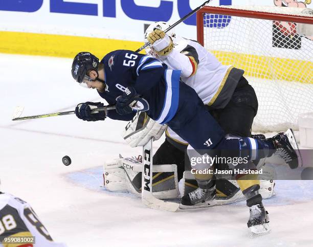 Brayden McNabb of the Vegas Golden Knights checks Mark Scheifele of the Winnipeg Jets in Game Two of the Western Conference Finals during the 2018...