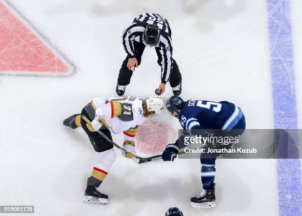 William Karlsson of the Vegas Golden Knights and Mark Scheifele of the Winnipeg Jets get set during a second period face-off in Game One of the...