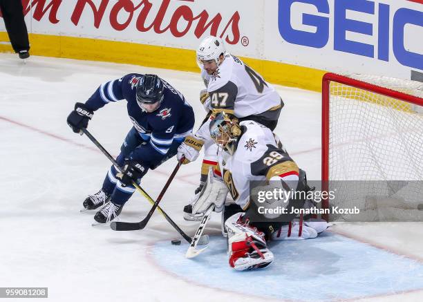 Luca Sbisa and goaltender Marc-Andre Fleury of the Vegas Golden Knights guard the net as Andrew Copp of the Winnipeg Jets tries to score during...