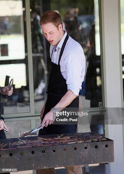 Prince William helps out with the cooking at a BBQ at Flowerdale north of Melbourne after he spent the day in towns affected by the Black Saturday...