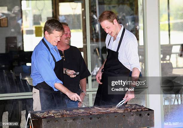 Prince William helps out with the cooking at a BBQ at Flowerdale north of Melbourne after he spent the day in towns affected by the Black Saturday...