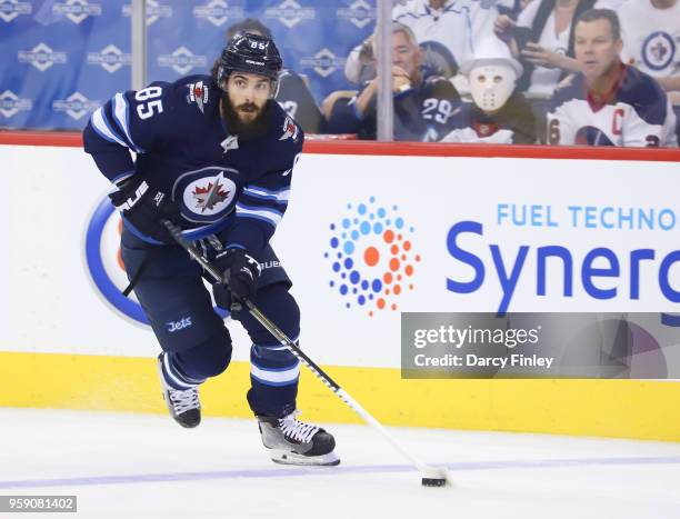 Mathieu Perreault of the Winnipeg Jets plays the puck down the ice during first period action against the Vegas Golden Knights in Game One of the...