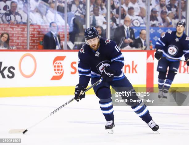 Bryan Little of the Winnipeg Jets plays the puck down the ice during third period action against the Vegas Golden Knights in Game One of the Western...
