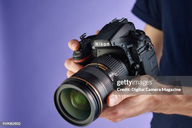 Detail of a man holding a Nikon D810 digital SLR camera, taken on August 23, 2016.