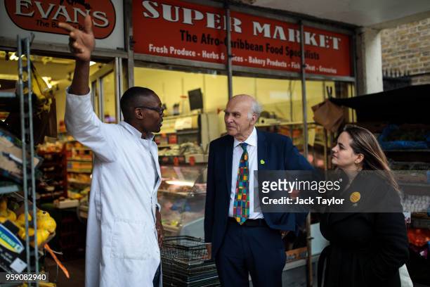 Liberal Democrat Leader Vince Cable and Liberal Democrat Parliamentary candidate for Lewisham East, Lucy Salek speak to a shop worker in Catford...