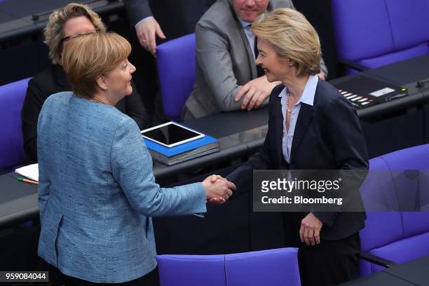 Angela Merkel, Germany's chancellor, left, shakes hands with Ursula von der Leyen, Germany's defense minister, ahead of a debate in the lower-house...