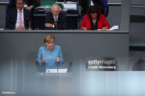 Angela Merkel, Germany's chancellor, speaks during a budget policy plan debate as Wolfgang Schaeuble, president of the Bundestag, rear center, looks...