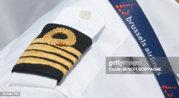 Commander's epaulette and airline logo are seen on the shirt of a Brussels Airlines pilot as negotiations start between pilots and management at...