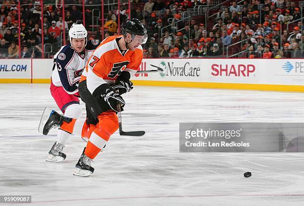Jeff Carter of the Philadelphia Flyers skates the puck past Marc Methot of the Columbus Blue Jackets on January 19, 2010 at the Wachovia Center in...