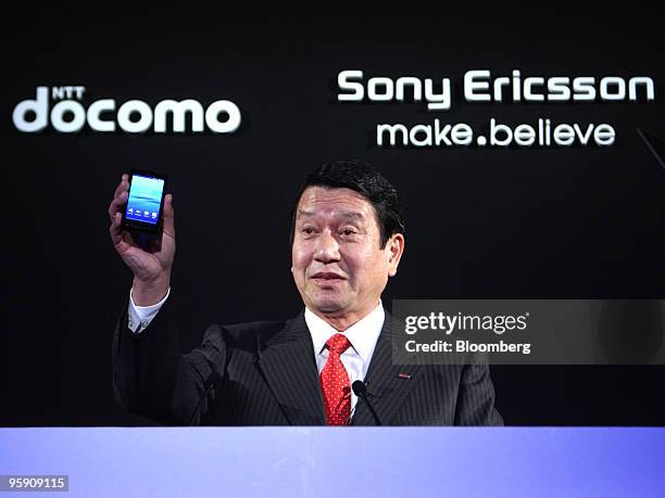 Ryuji Yamada, president of NTT DoCoMo Inc., holds up the Xperia smart phone during the launch held with Bert Nordberg, president and chief executive...