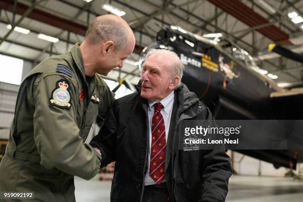 Wing Commander John Butcher, Commanding Officer of 617 Squadron, jokes with Britain's last surviving 'Dambuster', Squadron Leader George "Johnny"...