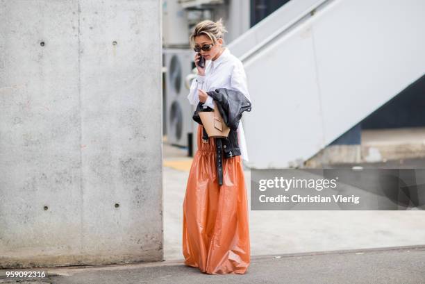 Yan Yan Chan wearing long orange skirt, white blouse during Mercedes-Benz Fashion Week Resort 19 Collections at Carriageworks on May 16, 2018 in...