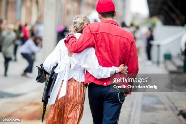 Couple holding each other in the arms while walking away during Mercedes-Benz Fashion Week Resort 19 Collections at Carriageworks on May 16, 2018 in...