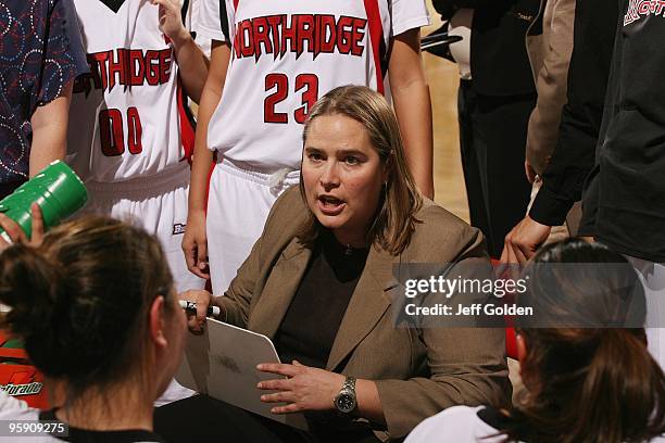 Head coach Staci Schulz of the Cal State Northridge Matadors instructs her team during a timeout in the second half of the women's college basketball...