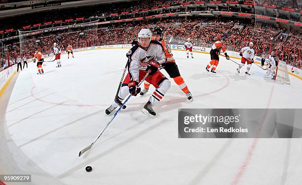 Mike Richards of the Philadelphia Flyers battles for a loose puck against Marc Methot of the Columbus Blue Jackets on January 19, 2010 at the...