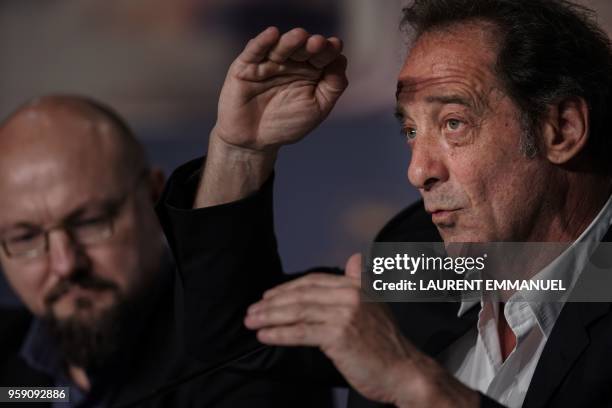 French actor Vincent Lindon speaks as French actor Olivier Lemaire looks on during a press conference on May 16, 2018 for the film "At war " at the...