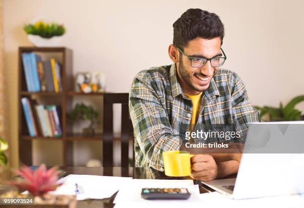 man calculating bills in home office - businessman working on a laptop with a coffee stock pictures, royalty-free photos & images