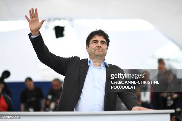 French director Romain Goupil poses on May 16, 2018 during a photocall for the film "On the Road in France " at the 71st edition of the Cannes Film...
