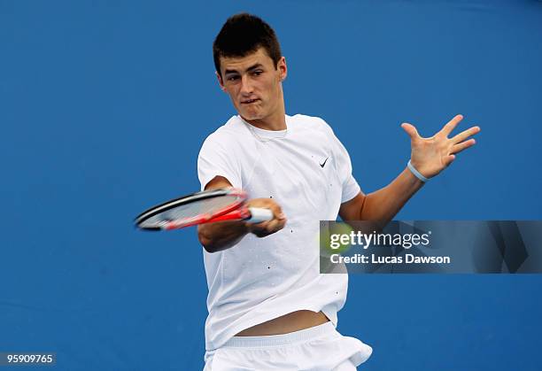 Bernard Tomic of Australia plays a forehand in his first round doubles match with Marinko Matosevic of Australia against Martin Damm of the Czech...