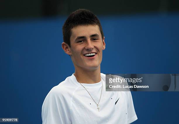 Bernard Tomic of Australia smiles in his first round doubles match with Marinko Matosevic of Australia against Martin Damm of the Czech Republic and...