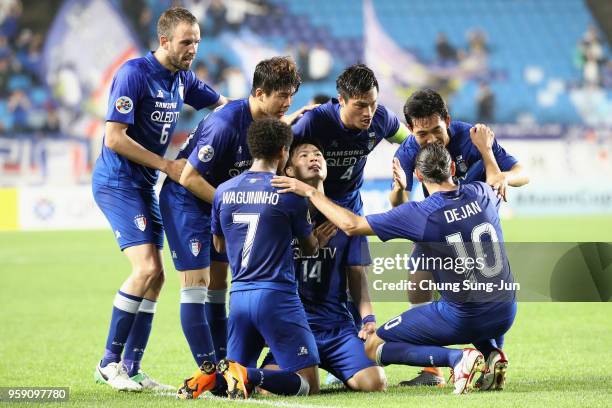 Kim Gun-hee of Suwon Samsung Bluewings celebrates scoring his side's second goal with his team mates during the AFC Champions League Round of 16...