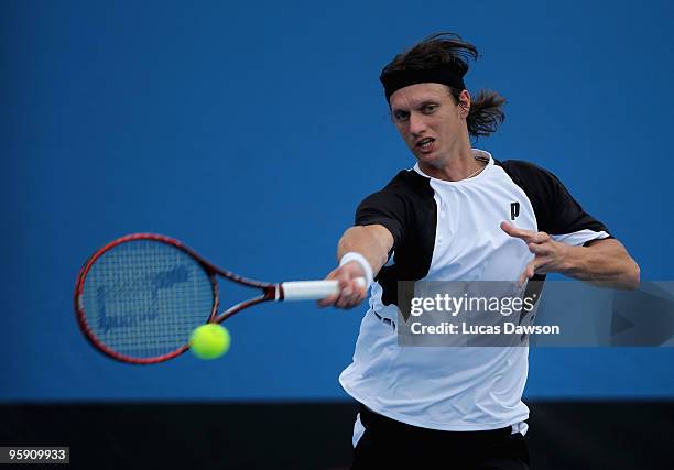 Filip Polasek of Slovakia plays a forehand in his first round doubles match with Martin Damm of the Czech Republic against Bernard Tomic and Marinko...