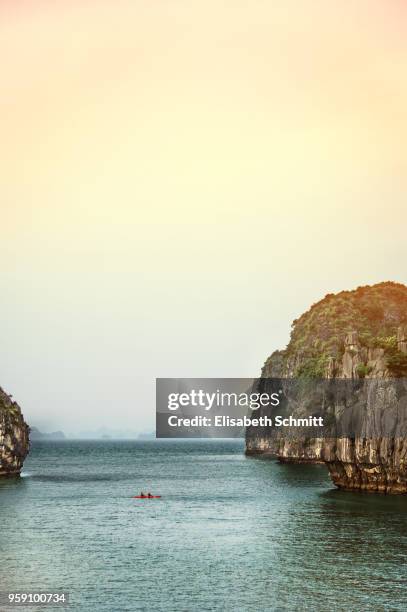 two tourists in a kayak in halong bay, vietnam - quang ninh stock pictures, royalty-free photos & images