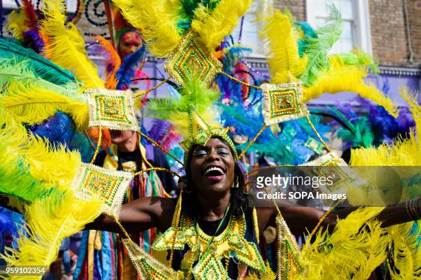 Parade participant in a brightly-coloured costume strikes a pose on the second and final day of the 2016 Notting Hill Carnival in west Londonby some...