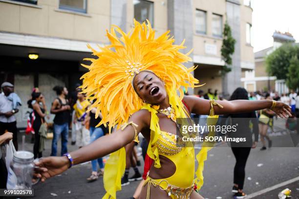Parade participant in a brightly-coloured costume strikes a pose on the second and final day of the 2016 Notting Hill Carnival in west Londonby some...