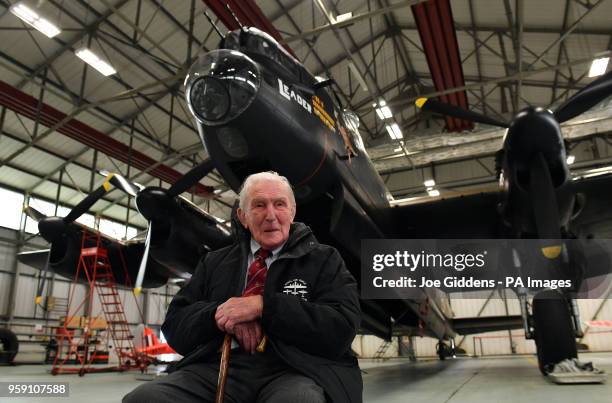 Johnny Johnson, the last survivor of the original Dambusters of 617 Squadron, sits beneath an Avro Lancaster bomber at RAF Coningsby, Lincolnshire.