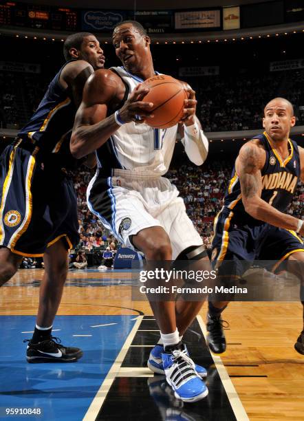 Dwight Howard of the Orlando Magic moves the ball against Solomon Jones of the Indiana Pacers during the game on January 20, 2010 at Amway Arena in...