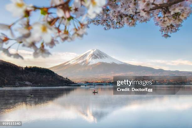 fuji mountain reflection and fisherman boat with sakura in spring blue sky sunny day at kawaguchiko  lake - mt fuji stock-fotos und bilder