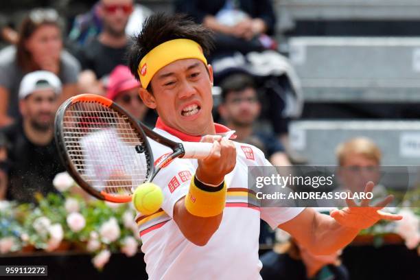 Japan's Kei Nishikori hits a return to Bulgaria's Grigor Dimitrov during Rome's ATP Tennis Open tournament at the Foro Italico, on May 16, 2018 in...