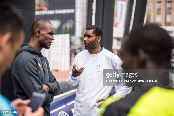 Eric Abidal chats with players of the International Homeless Team of France at the Fan Zone ahead of the UEFA Europa League Final between Olympique...